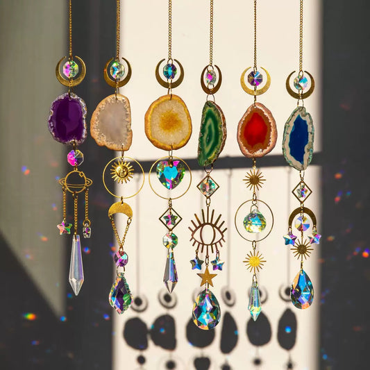 Colorful crystal wind chimes with various shapes and colors against a neutral background